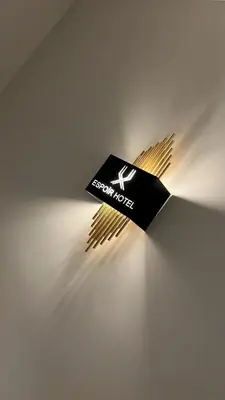 a black and gold sign on a wall at Espoir HOTEL in Istanbul