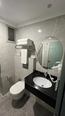 a bathroom with a sink and a toilet and a mirror at Espoir HOTEL in Istanbul