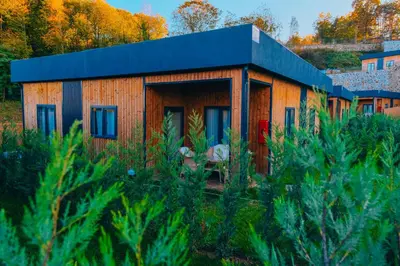 a small wooden house with a blue roof at The Green Park Sapanca in Sapanca