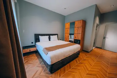 a bedroom with a large bed and a wooden floor at The Green Park Sapanca in Sapanca