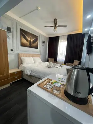 a bedroom with a bed and a tea kettle on a counter at Kıyı Butik Otel in Mimarsinan