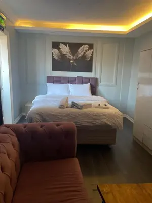 a bedroom with a bed and a couch in it at Kıyı Butik Otel in Mimarsinan