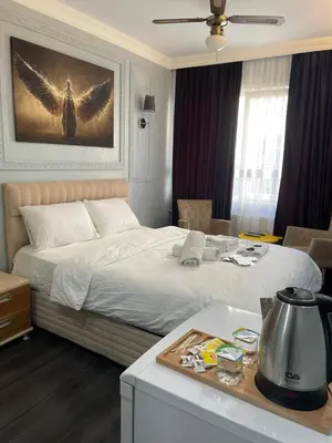 a bedroom with a large bed with wings on the wall at Kıyı Butik Otel in Mimarsinan