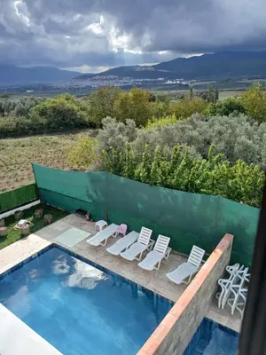 a swimming pool with lounge chairs and a swimming pool at Naturel villaları in Orhangazi