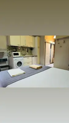 a white bed in a kitchen with two towels on it at Yaman suit in Istanbul