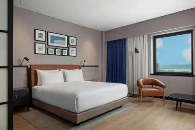 a bedroom with a bed and a chair and a window at Four Points by Sheraton Istanbul Pendik in Istanbul