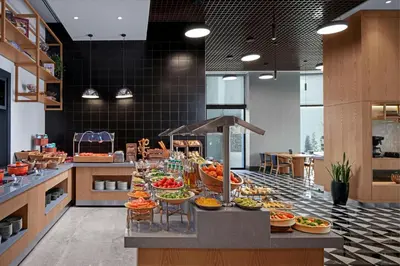 a buffet of food on a counter in a restaurant at Four Points by Sheraton Istanbul Pendik in Istanbul