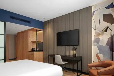 a bedroom with a bed and a desk and a television at Four Points by Sheraton Istanbul Pendik in Istanbul