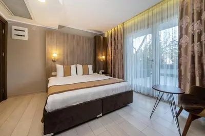 a hotel room with a bed and a large window at Royal Capital Hotel Bursa in Bursa