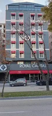 a tall building with cars parked in front of it at Royal Capital Hotel Bursa in Bursa