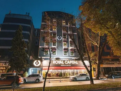 a tall building with cars parked in front of it at Royal Capital Hotel Bursa in Bursa
