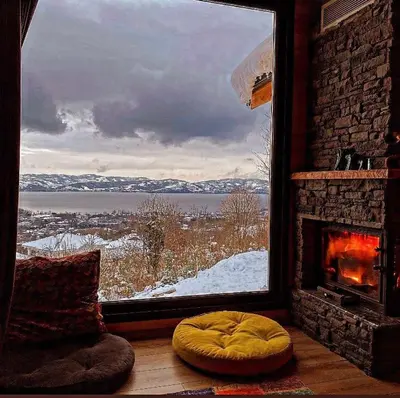 a room with a fireplace and a window with a view at papatya in Sapanca