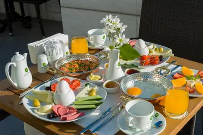 a table with plates of food and eggs and fruit at Bizim Hotel in Istanbul