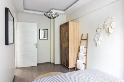 a bedroom with a bed and a white door at Pretty Corner Flat with Abundant Light in Kadikoy in Istanbul