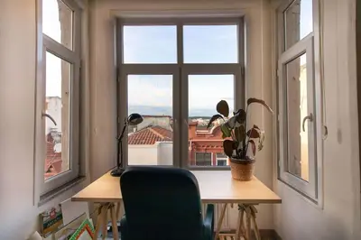 a room with a desk and a window with a plant at Soft and Historic 3BR Home w Iconic Haydarpasa View in Istanbul
