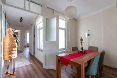 a dining room with a wooden table and chairs at Soft and Historic 3BR Home w Iconic Haydarpasa View in Istanbul