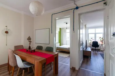 a dining room with a table and a bedroom at Soft and Historic 3BR Home w Iconic Haydarpasa View in Istanbul