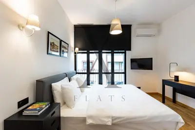 a bedroom with a large white bed and a window at X Flats Kaiser in Istanbul