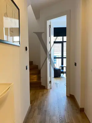 a hallway with an open door and a stairway at X Flats Kaiser in Istanbul