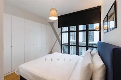 a bedroom with a white bed and a window at X Flats Kaiser in Istanbul