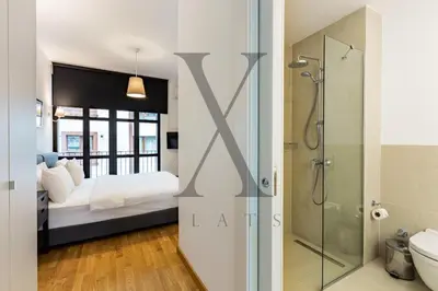 a bedroom with a king sized bed and a shower at X Flats Kaiser in Istanbul