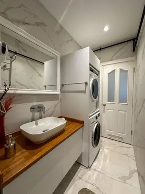 a bathroom with a sink and a washing machine at ŞAHİN PERA SUİT 1 stylish 2Br 3Ac apartment near Istiklal street in Istanbul