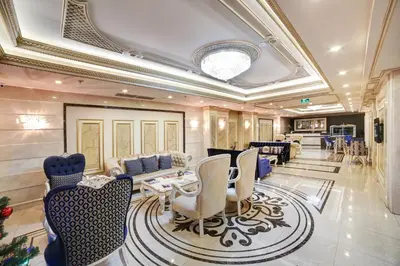 a living room with a table and chairs at Halifaks Hotel in Istanbul