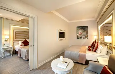 a hotel room with two beds and a couch at Halifaks Hotel in Istanbul