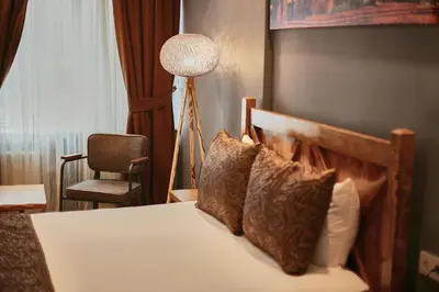 a bedroom with a bed with a lamp and a chair at Zengin City Hotel in Istanbul