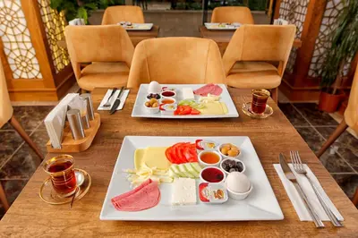 a table with two plates of food on it at Zengin City Hotel in Istanbul
