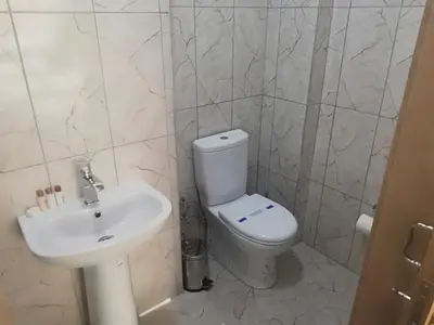 a bathroom with a white toilet and a sink at Zengin City Hotel in Istanbul