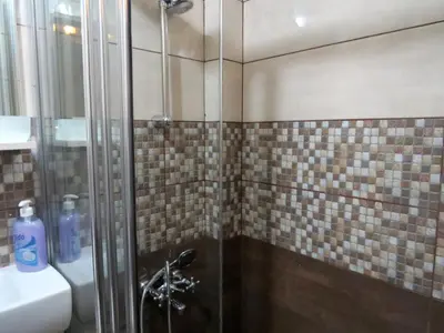 a shower with a glass door next to a sink at Istanberry - Pera Apartments in Istanbul