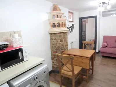 a small kitchen with a table and a microwave at Istanberry - Pera Apartments in Istanbul