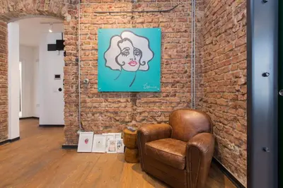 a chair in a room with a brick wall at Architect Jonas generous 85 sqm apartment full of Art in Istanbul