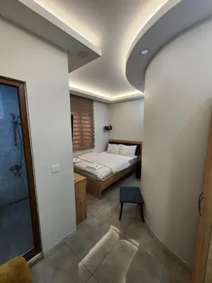 a small room with a bed and a chair at Acet Residence in Istanbul