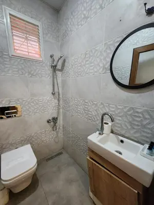 a bathroom with a sink and a toilet and a mirror at Acet Residence in Istanbul