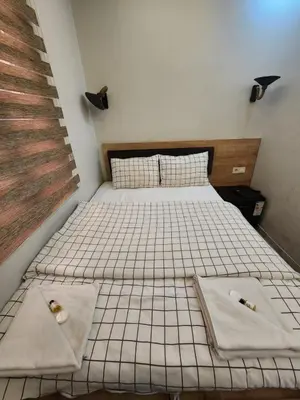 two beds in a room with towels on them at Acet Residence in Istanbul