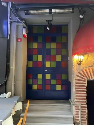 a colorful door in a room with a staircase at ŞAHİN PERA SUİT3 Central location 2 Br 3 Ac great apartment in Istanbul