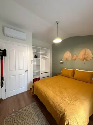 a bedroom with a yellow bed and a white door at ŞAHİN PERA SUİT3 Central location 2 Br 3 Ac great apartment in Istanbul