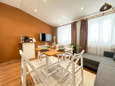 a living room with a table and chairs and a couch at ŞAHİN PERA SUİT3 Central location 2 Br 3 Ac great apartment in Istanbul