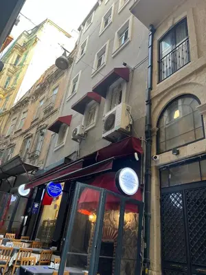 a restaurant on a street next to a building at ŞAHİN PERA SUİT3 Central location 2 Br 3 Ac great apartment in Istanbul