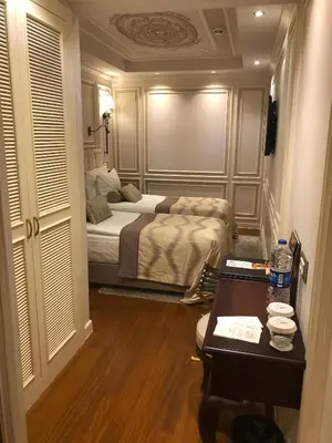 a bedroom with a bed and a table in it at Arcade Hotel & SPA Nisantasi in Istanbul