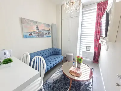 a living room with a blue couch and a table at Excellent Apartments Galata in Istanbul