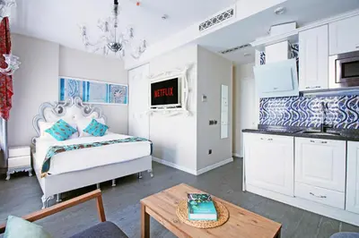 a bedroom with a bed and a table in a room at Excellent Apartments Galata in Istanbul