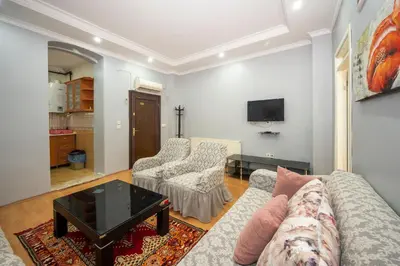 a living room with a couch and two chairs and a tv at TAKSIM SUITE Apartment in Istanbul