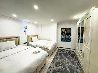 a bedroom with two beds and a painting on the wall at Sisli Apartments Holiday231 in Istanbul