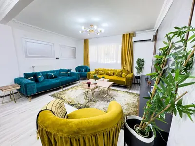 a living room with blue couches and yellow chairs at Sisli Apartments Holiday231 in Istanbul
