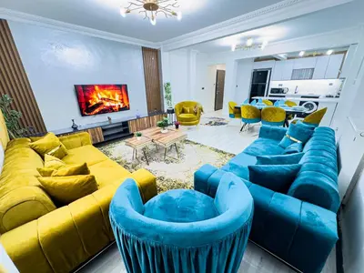 a living room with a blue couch and yellow furniture at Sisli Apartments Holiday231 in Istanbul
