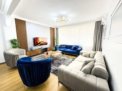 a living room with a couch and blue chairs at Sisli Apartments Holiday441 in Istanbul