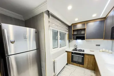 a kitchen with a stainless steel refrigerator and a window at Sisli Apartments Holiday441 in Istanbul